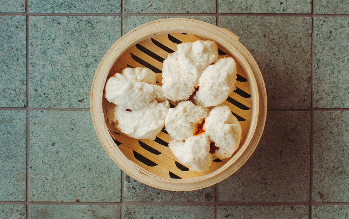 a bamboo basket of bbq pork buns